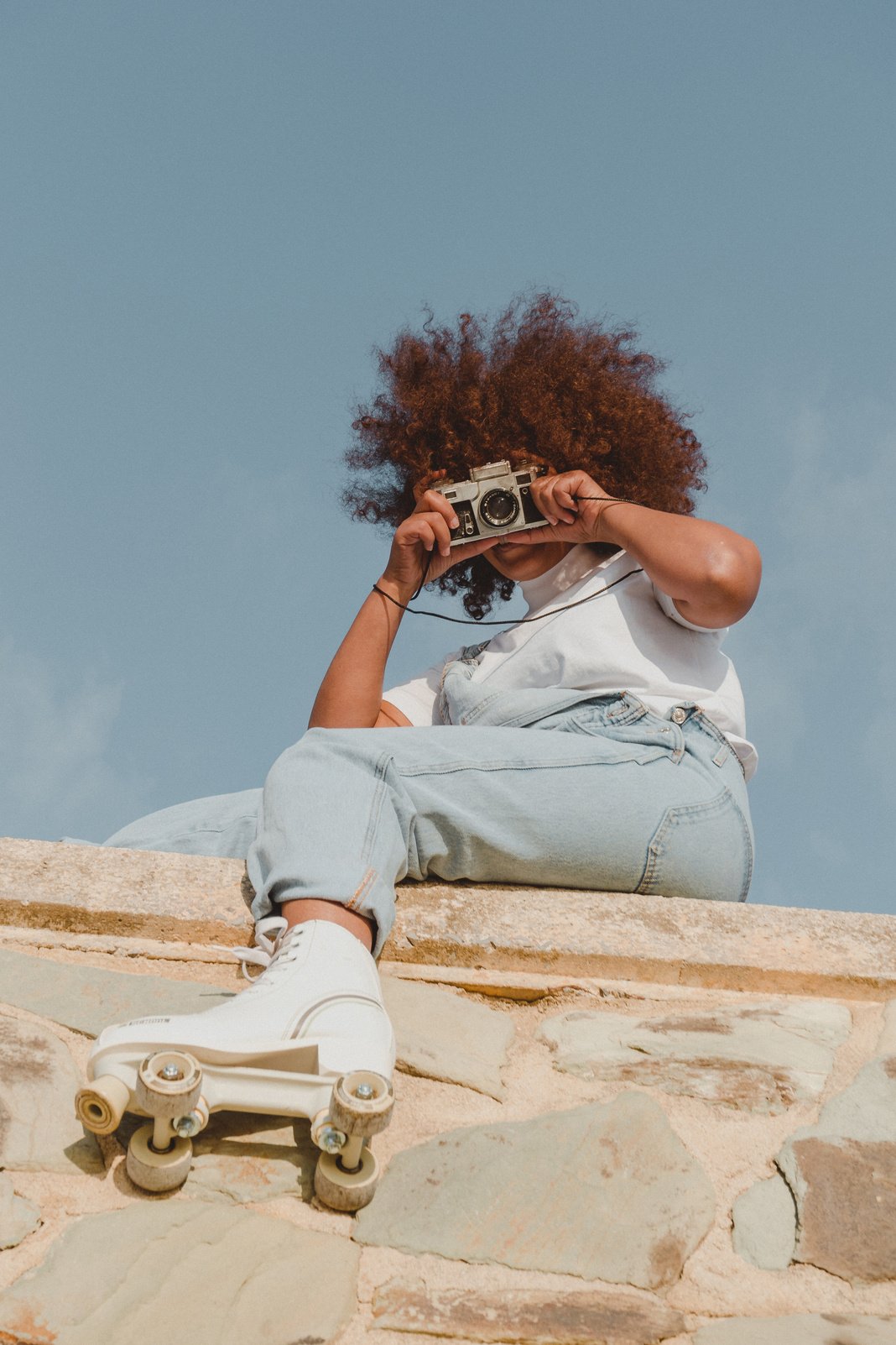 Woman Taking a Picture Using a Vintage Camera Outdoors